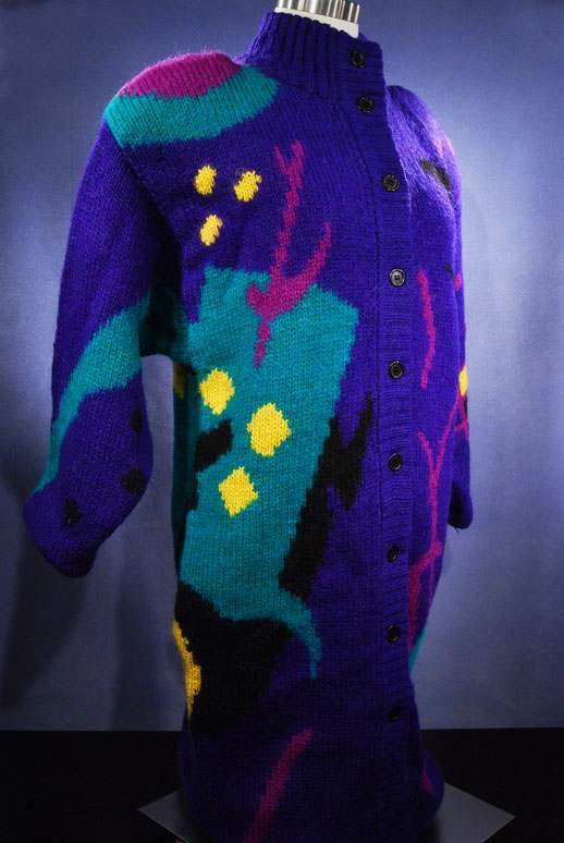Woman's brightly colored wool sweater-coat with desert motif and button-up front