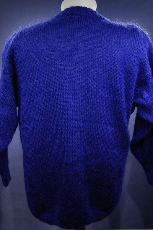 Woman's colorful deep V-neck jewel-tone sweater with geometric design by Nell Flowers shown from back