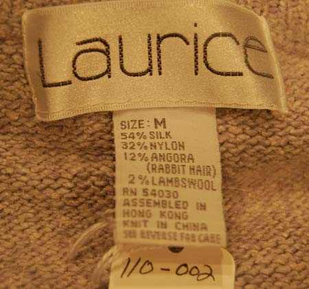 Close-up of Laurice label and fabric tag on woman's medium grey silk-angora cardigan sweater