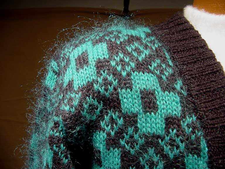 Plus sized woman's retro green and black mohair-blend deep V-neck cardigan sweater