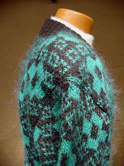 Plus-sized woman's retro green and black mohair-blend cardigan sweater with deep V-neck
