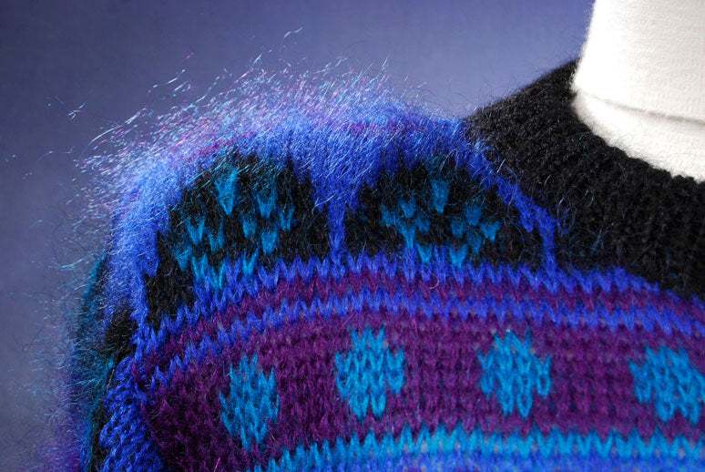 Woman's blue multi-colored retro mohair crewneck sweater with black trim by Gallagher