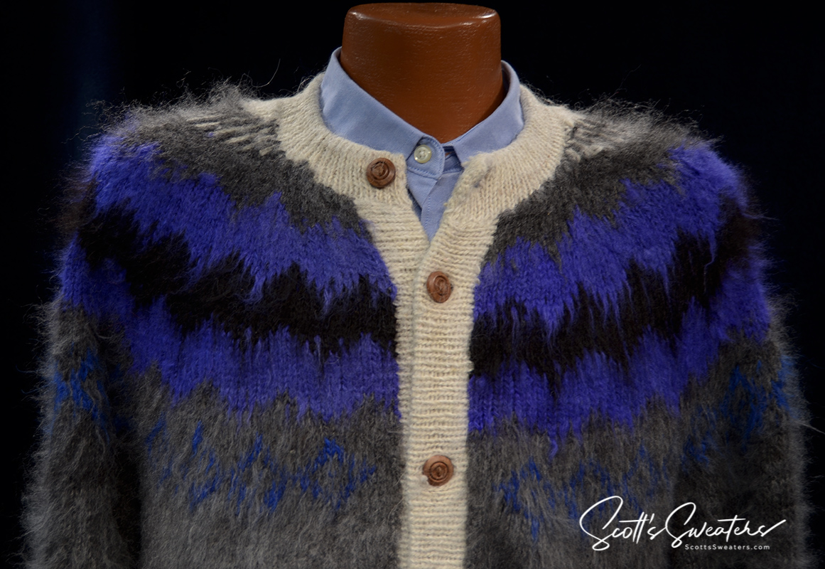 Unisex soft alpaca cardigan sweater in grey with blue and black yoke design and white trim, button-up style.