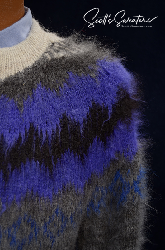 Close-up of a unisex wonderfully soft alpaca cardigan sweater with blue and black yoke design and white trim.