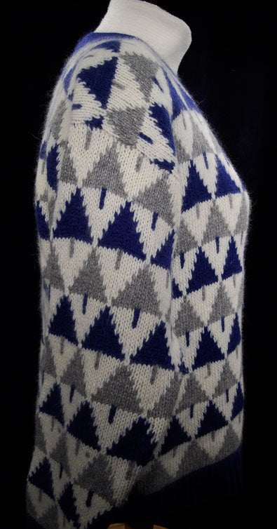 Woman's blue, grey, and white angora-lambswool Christmas tree pattern cardigan sweater side view