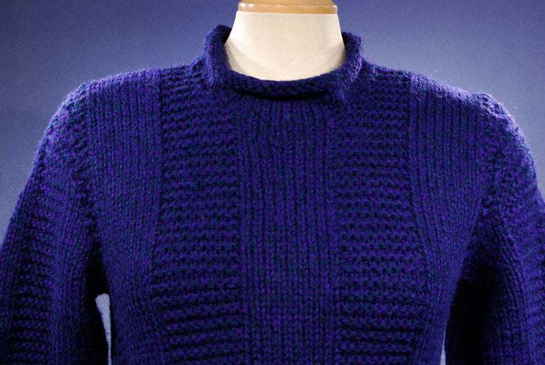 Woman's dark-blue hand-knit wool-acrylic rollneck sweater in navy blue on mannequin
