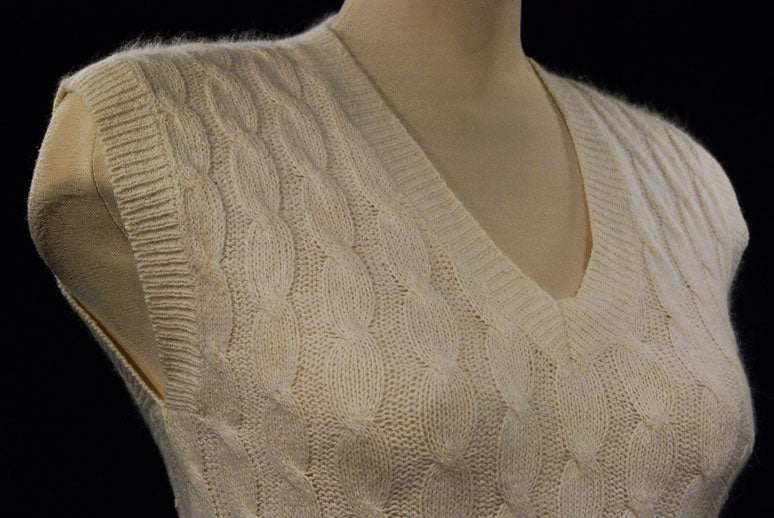 Woman's white silk-cotton-angora cable-knit sweater vest with V-neck on mannequin