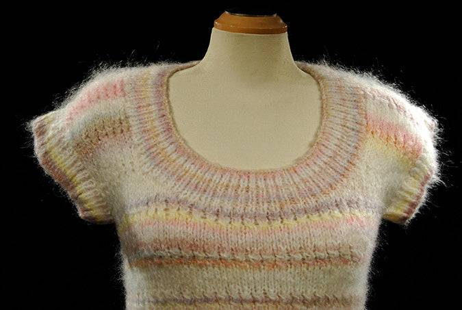 White hand-knit sleeveless sweater vest with pastel horizontal stripes for women or girls spring and summer
