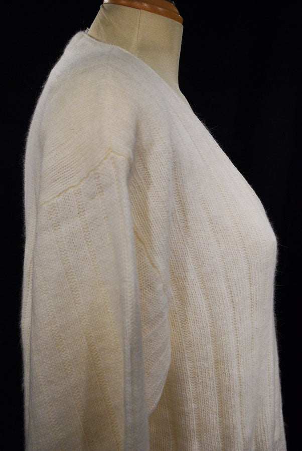 Plus-sized white angora V-neck sweater by New York Studio displayed on a mannequin side view