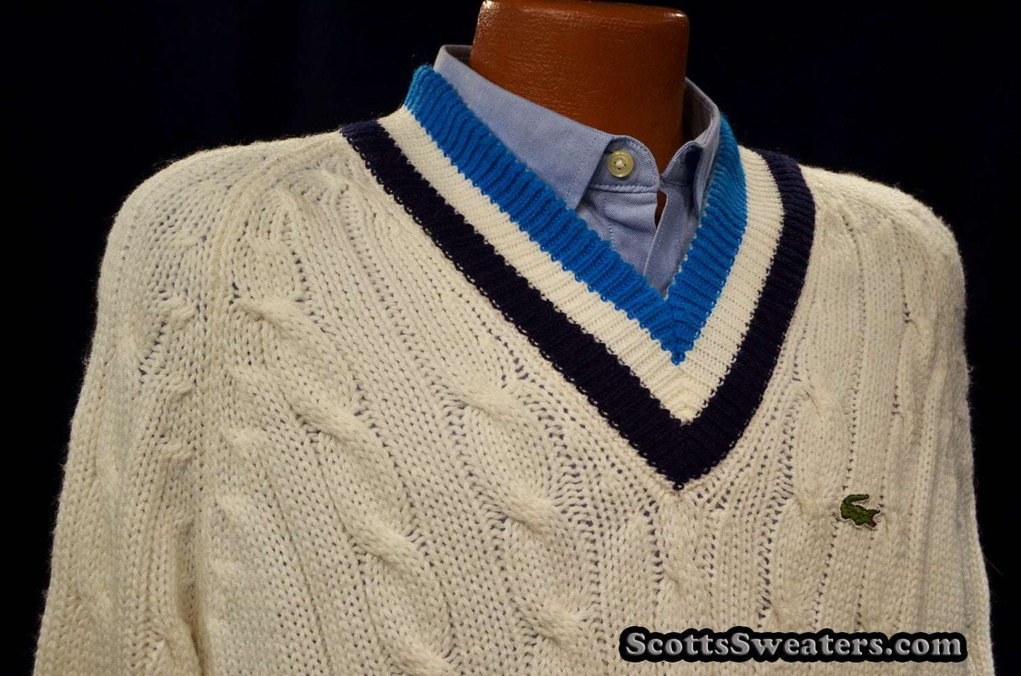 Men's classic retro Izod cable-knit tennis sweater with black and blue striped V-neck and Lacoste crocodile logo