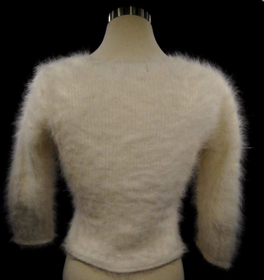 Woman's sexy cropped 3/4-sleeve angora sweater in beige with fuzzy texture and cling-fit design
