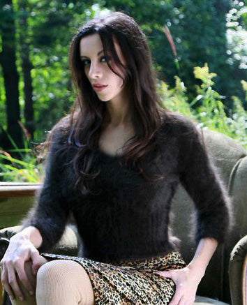 Women's Sexy Angora Sweater cropped V-neck sweater with 3/4 sleeves sitting outdoors