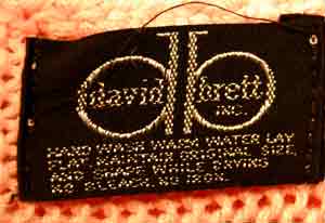 Close-up of label on woman's beaded-pink angora sweater by David Brett Inc, size 36.