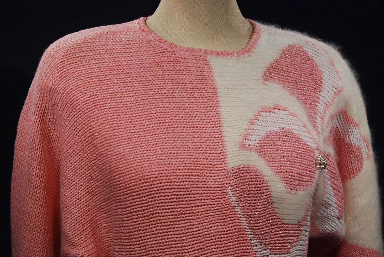 Woman's pink angora sweater with large white beaded floral design on left shoulder by David Brett, size 36