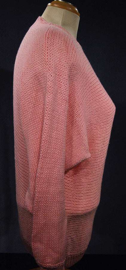 Pink woman's angora sweater with white beaded design on left shoulder by David Brett, size 36