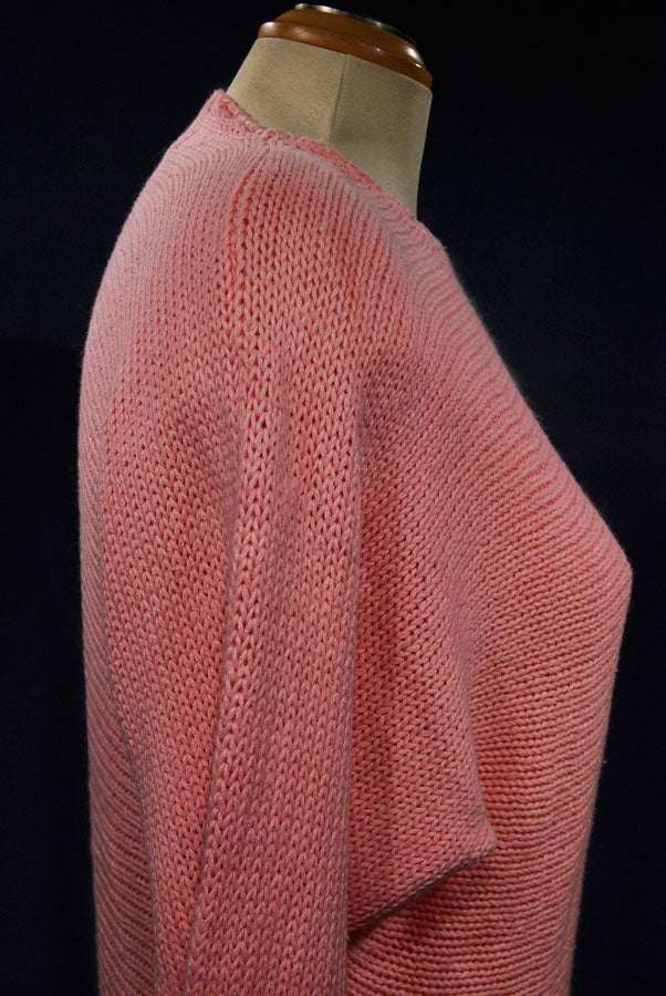 Woman's beaded-pink angora sweater by David Brett shown from side angle on mannequin