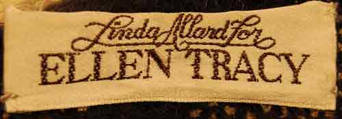 Woman's long black mohair blend cardigan with metallic gold crest design by Linda Alland for Ellen Tracy