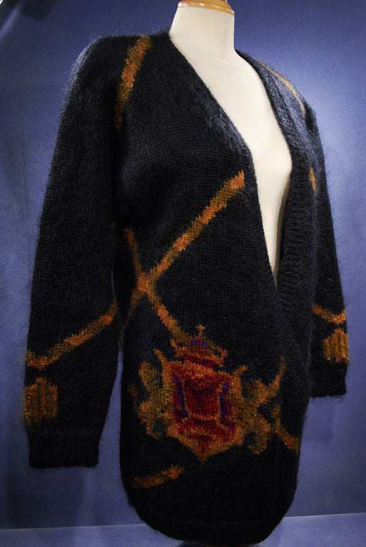 Woman's long black mohair blend cardigan sweater with metallic gold crest design
