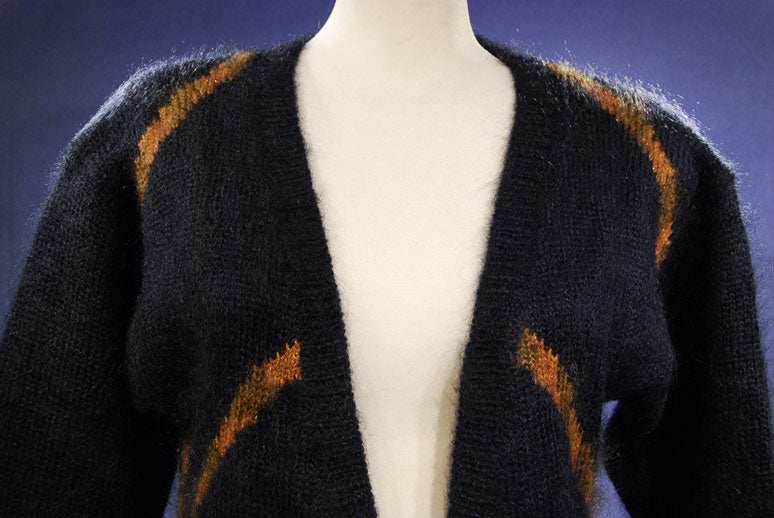 Woman's long black mohair cardigan sweater with metallic gold crest design by Ellen Tracy