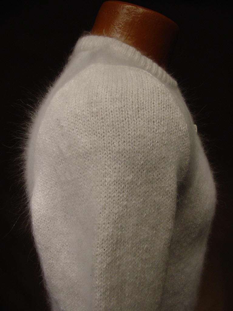 Teen girl's cropped zipper-front natural white silk-angora cardigan sweater displayed on mannequin