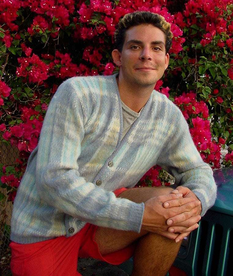 Men's rare retro light-blue plaid mohair cardigan sweater modeled outdoors with red flowers background