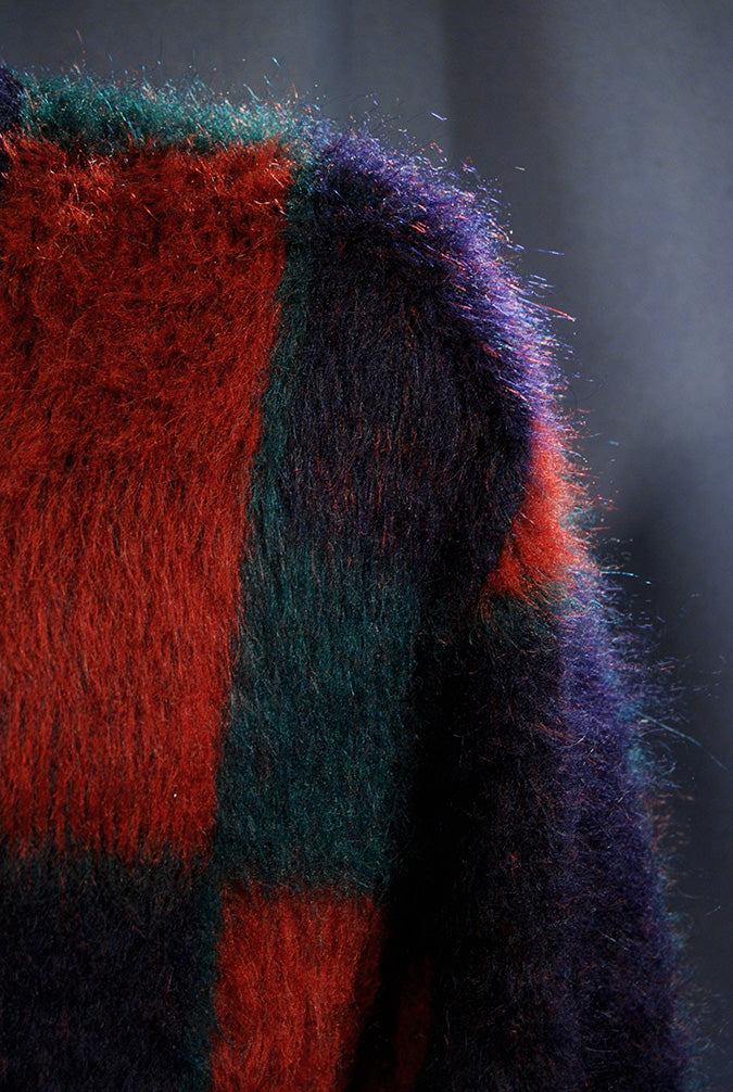 Close-up of retro classic original mohair V-neck sweater with blue, red, and green block pattern by Munsingwear
