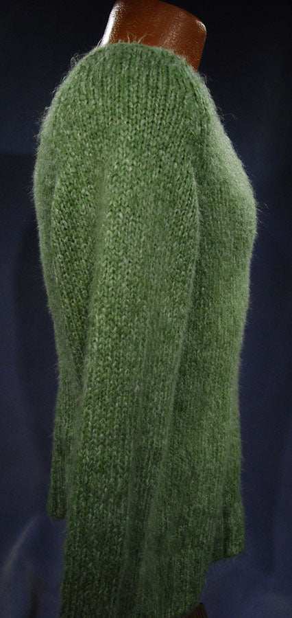 Woman's sage-green fuzzy V-neck sweater pullover displayed on mannequin against dark background