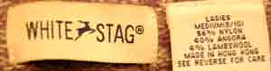 Close-up of White Stag label on woman's purple and white angora blend V-neck sweater, medium size