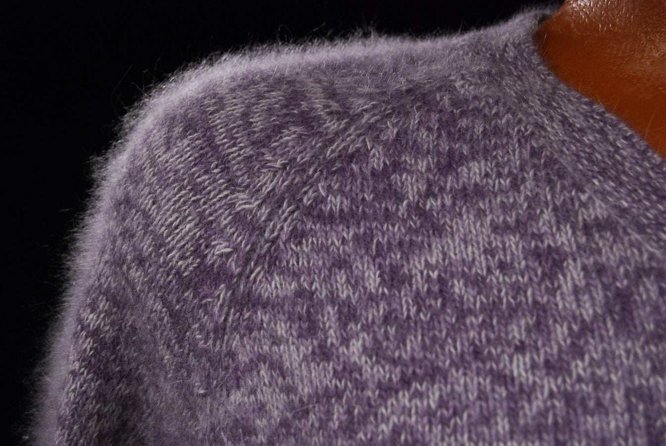 Close-up of woman's purple and white angora blend V-neck sweater by White Stag in medium size