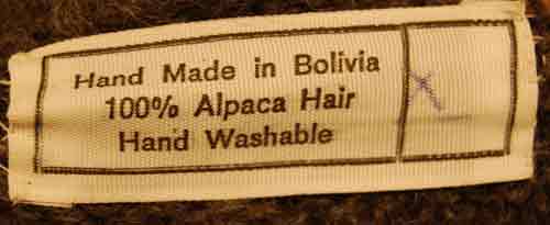 Grey ultra-soft alpaca V-neck sweater with orange chest stripes and llama design, made in Bolivia