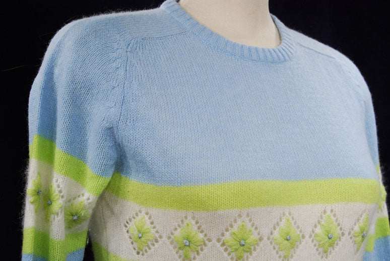 Girl's powder-blue angora crewneck sweater with white and lime green diamond design, medium size
