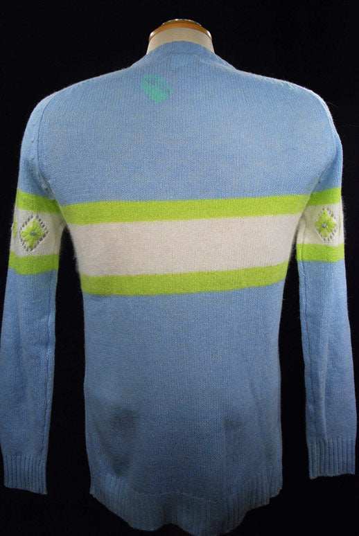 Girl's powder-blue angora crewneck sweater with white and lime green design, medium size