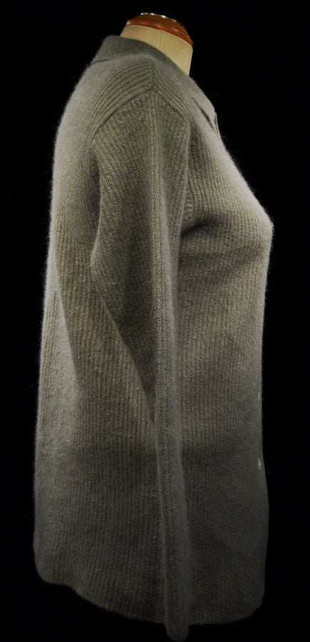 Side view of a woman's olive-green angora cardigan sweater-shirt with 3/4-length sleeves and lapels, size 38