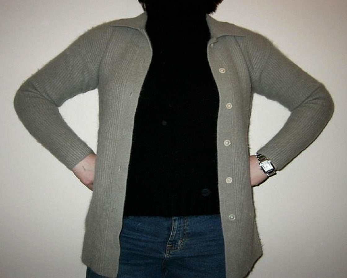 Woman wearing olive-green angora cardigan with 3/4-length sleeves and button front