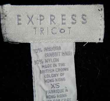 Close-up of Express Tricot label on woman's black angora cardigan sweater in X-small size