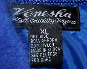 Close-up of Venesha brand powder-blue angora cardigan sweater size XL label showing fabric and care details