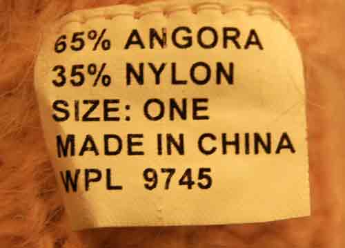 Label showing composition and size of woman's pink angora knit cap