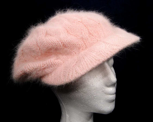 Woman's pink angora cable-knit cap on mannequin head