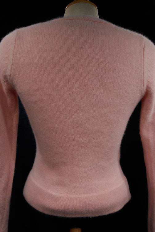 Back view of woman's pink angora-lambswool wrap-cardigan sweater with long sleeves.
