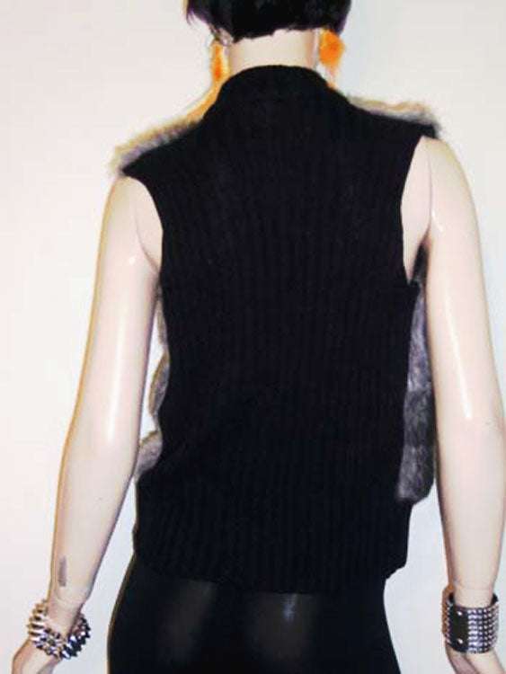 Back view of girl's/woman's grey and black faux-fur sleeveless zipper-front vest with rib-knit trim and soft texture.