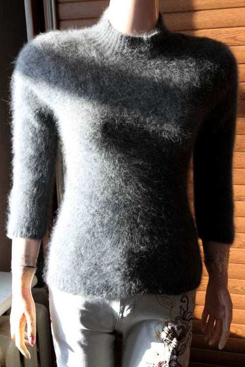 Woman's grey mock-turtleneck angora three-quarter sleeve sweater on mannequin