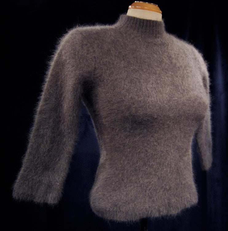 Woman's grey angora mock-turtleneck sweater with three-quarter sleeves on mannequin