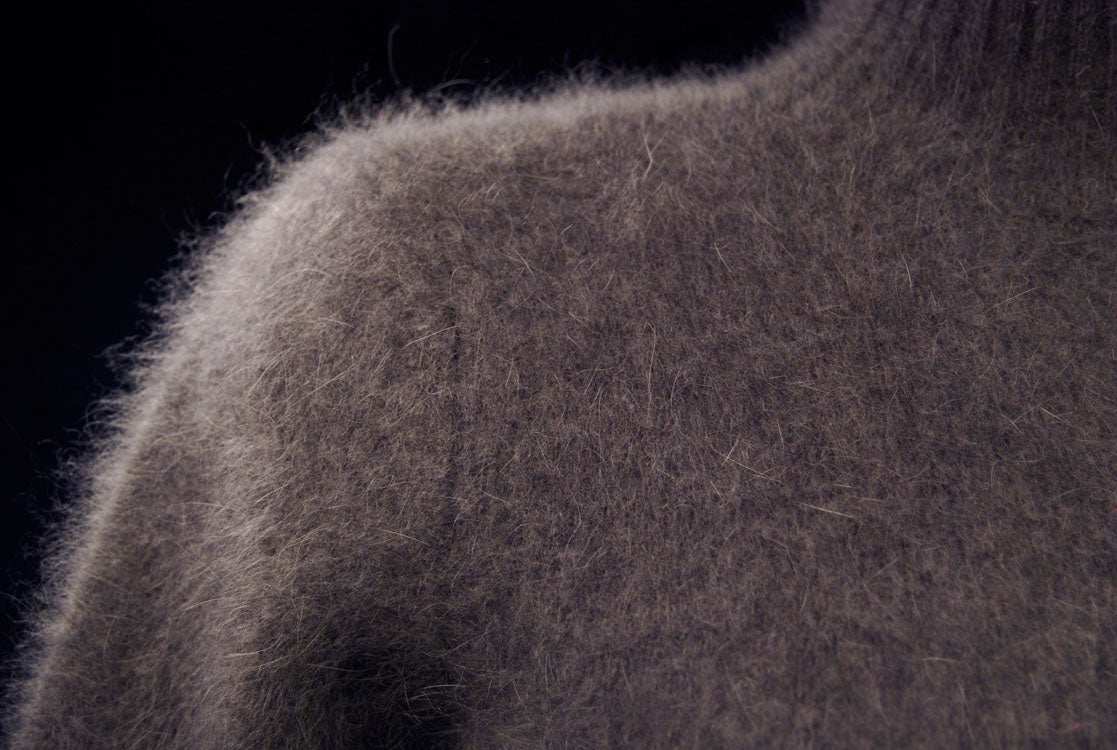 Close-up of brownish-gray angora mock turtleneck sweater with three-quarter sleeves for women