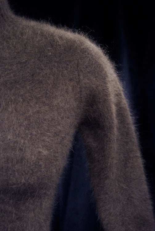 Brownish-gray angora woman's grey mock-turtleneck three-quarter sleeve sweater close-up