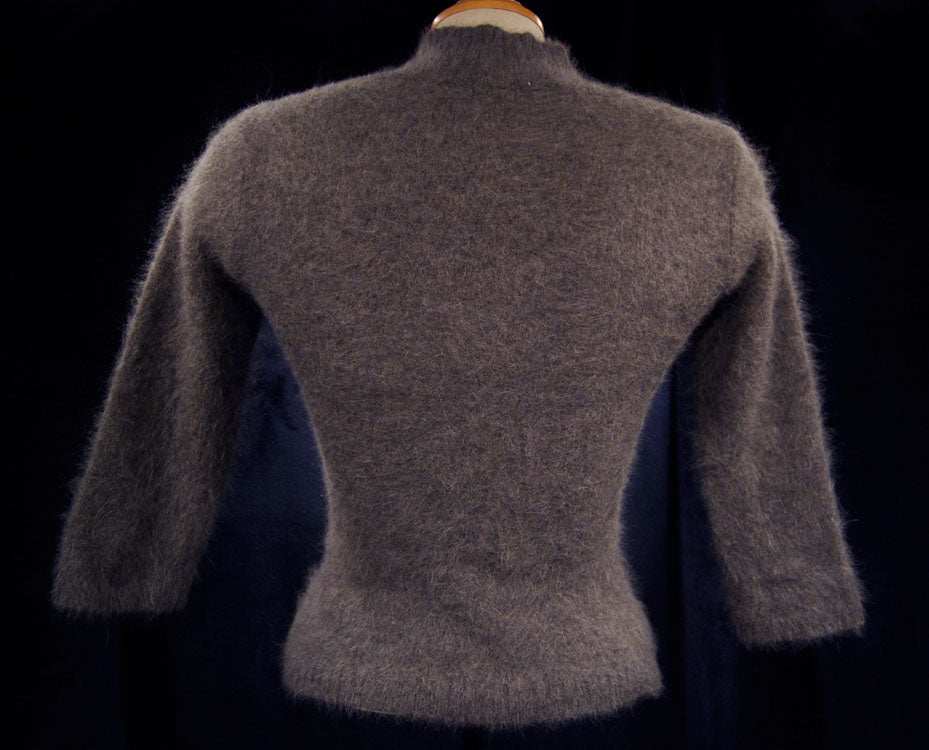Brownish-gray angora woman's mock-turtleneck sweater with three-quarter sleeves on mannequin back view