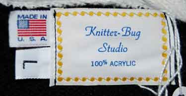 Label of Knitter-Bug Studio woman's black cardigan tennis sweater with white trim, 100% acrylic, made in USA, size large