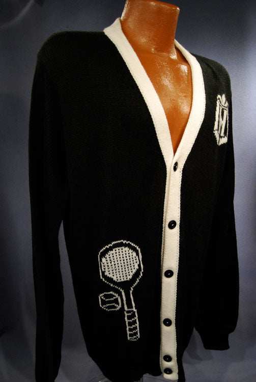 Woman's black cardigan sweater with white trim and tennis racket design
