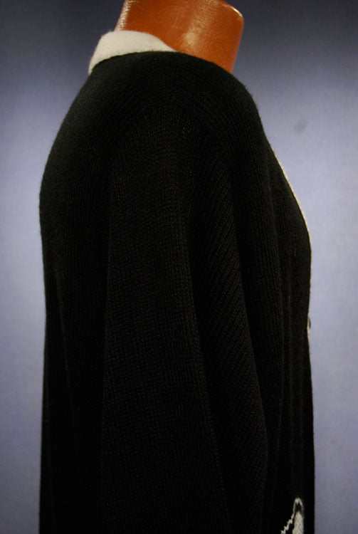 Woman's black cardigan tennis sweater with white trim and tennis racket design front view