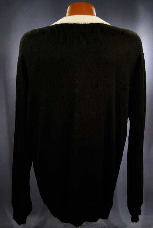Woman's black cardigan sweater with white trim shown from back