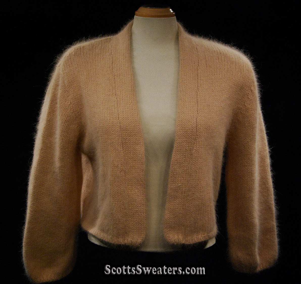 Woman's angora shrug cardigan sweater with open front and three-quarter sleeves in soft beige color